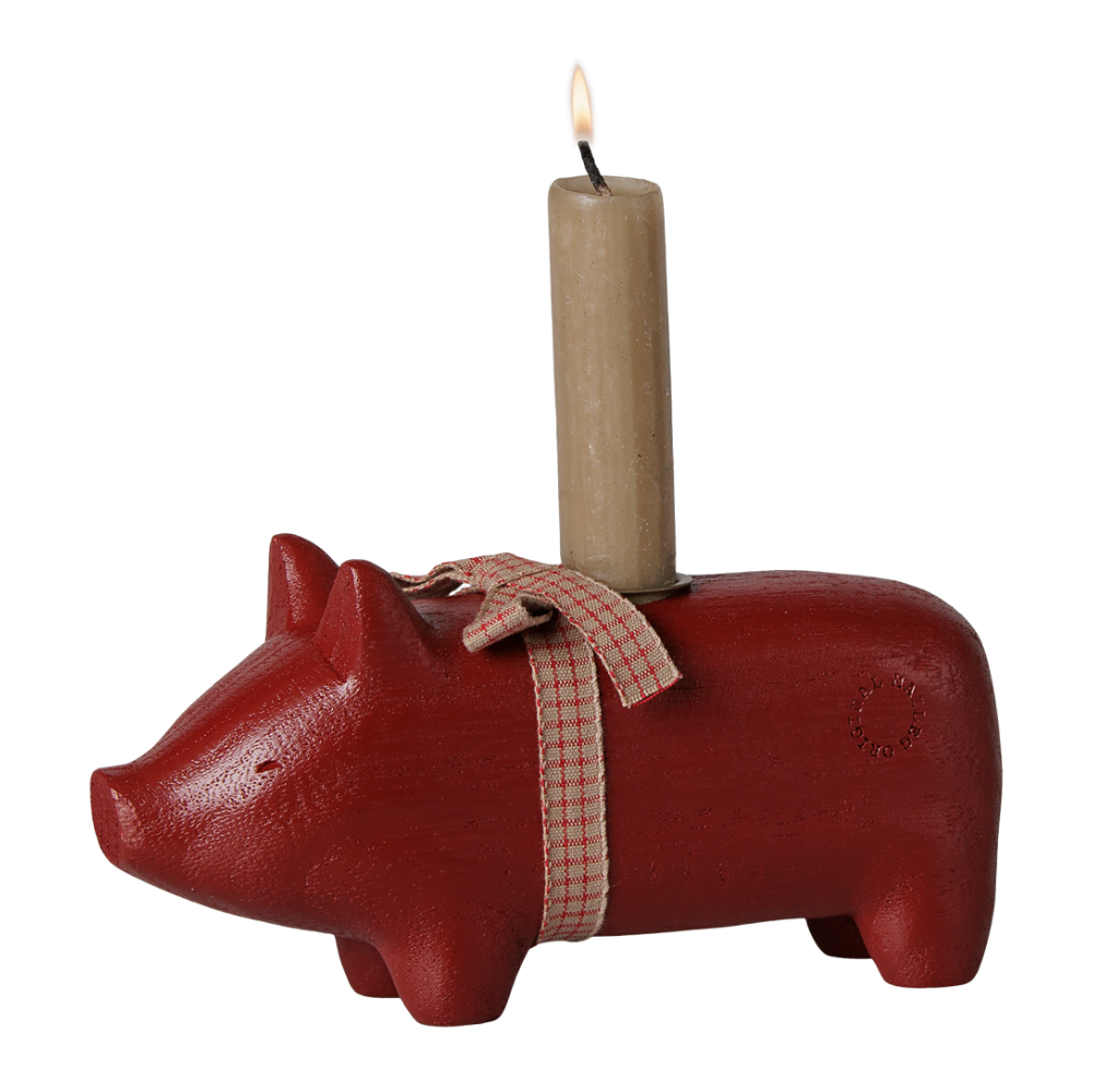 Rotes Holzschwein mit Kerzenhalter und Kerze