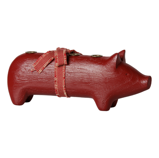 Rotes Holzschwein für 4 dünne Kerzen.